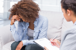 a woman and counselor in a PTSD therapy session